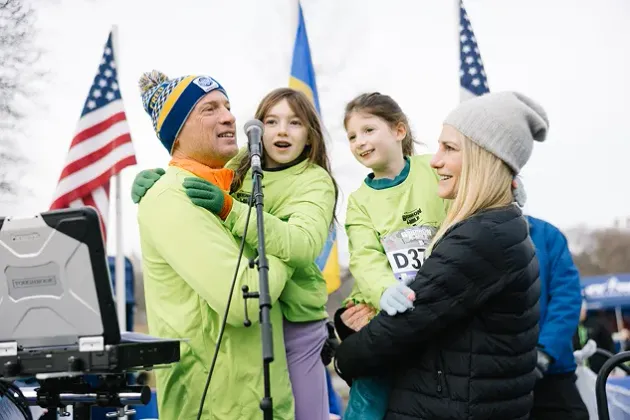 Family celebrating on stage at a race finish